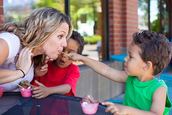 Family at the ice cream shop, sitting outside.