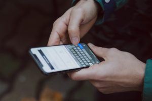 Person typing on cell phone