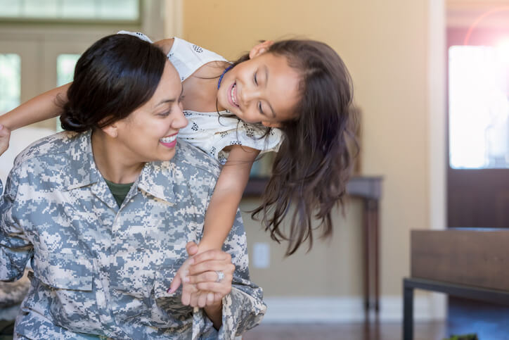 Female soldier playing with daughter