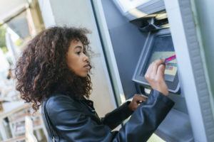 Woman using ATM