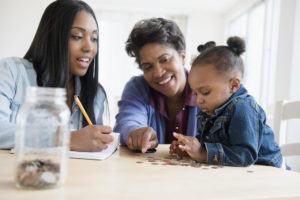 Mother, daughter and grandmother  counting coins