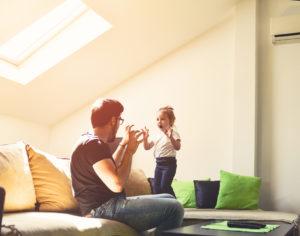 Father and daughter are pretending to be monsters, living room, roof window, sofa