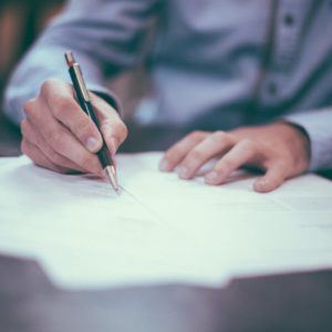 Man writing on piece of paper