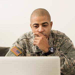 Serviceman looking at a laptop