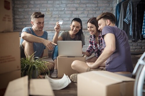 Friends looking at computer with credit card