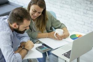 Man and Woman Reviewing Calculator