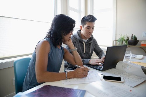 Man and woman working on a laptop together