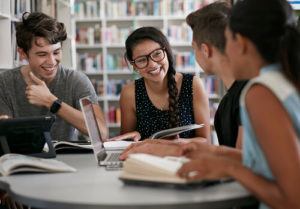 Students studying and laughing in a library