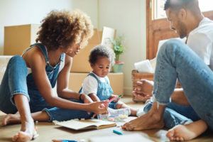 Parents coloring with child in front of moving boxes