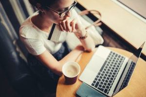 Woman making credit card purchase on laptop