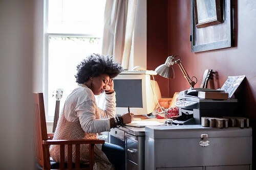 Woman writing at her desk