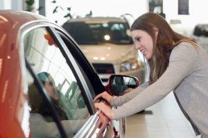 Woman shopping for car at dealership