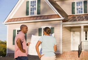 Couple looking at blueprints of new home