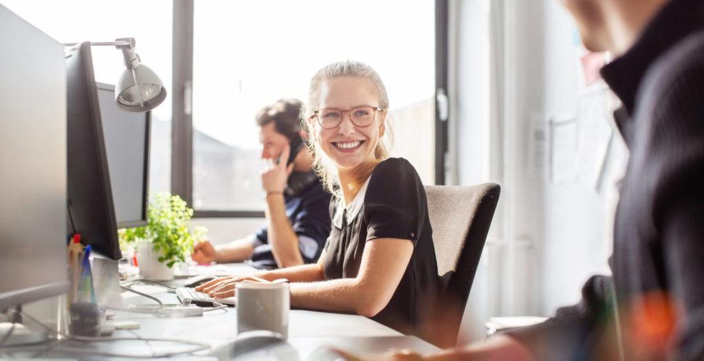 Woman smiling in sunny office