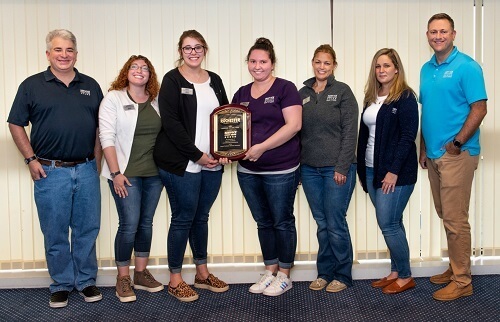 Service CU staff pose with Business of the Year plaque