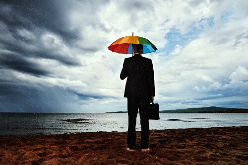 Man holding umbrella in rain