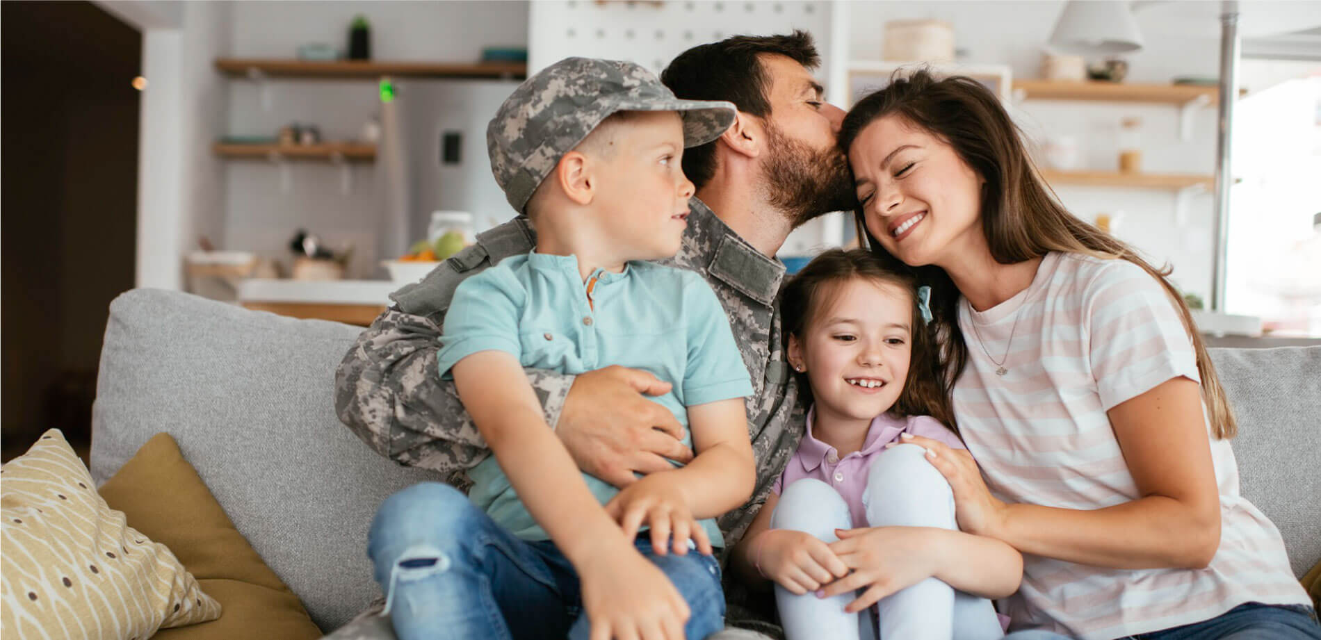 Military family sitting on couch