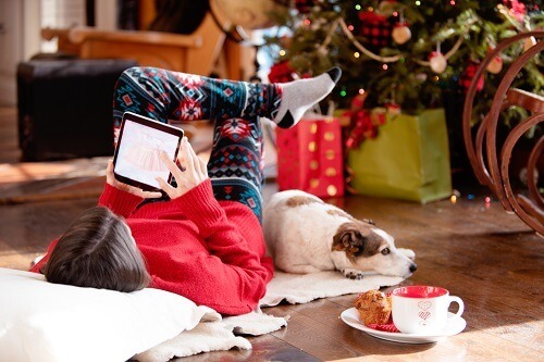 Woman Online Shopping By Christmas Tree