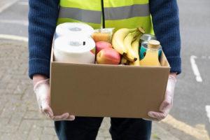 Man carrying box of food donations