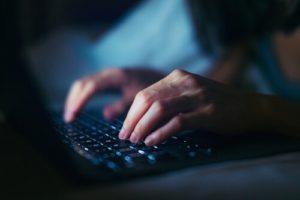 Woman typing on laptop