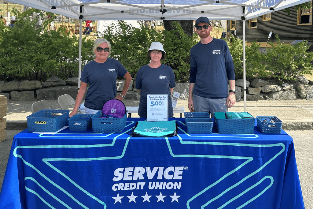 Credit union volunteers greeted attendees at the 34th American Independence Festival, sponsored by Service CU.