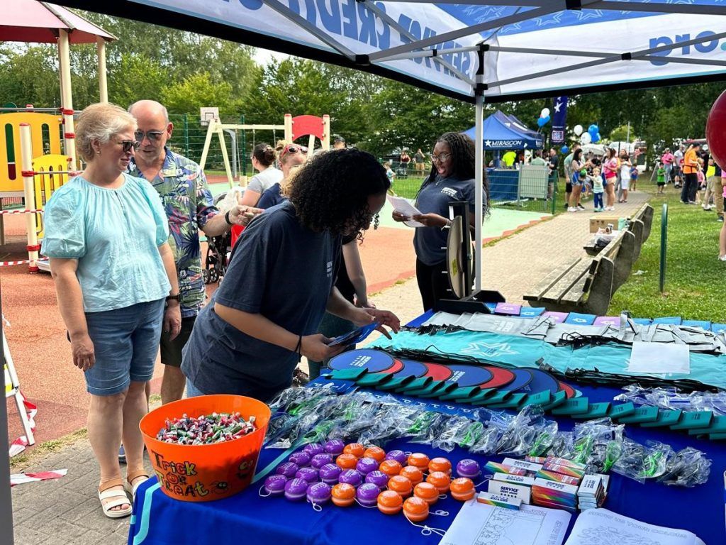 Service CU attended the Sun and Fun event with family-friendly activities, including a spinning wheel with financial trivia and a lively cornhole tournament.