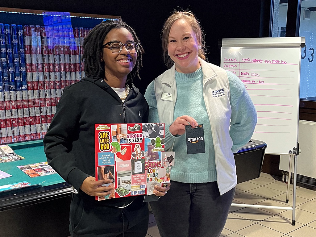 Service CU's Jessica Charles with a winner of the vision board contest.