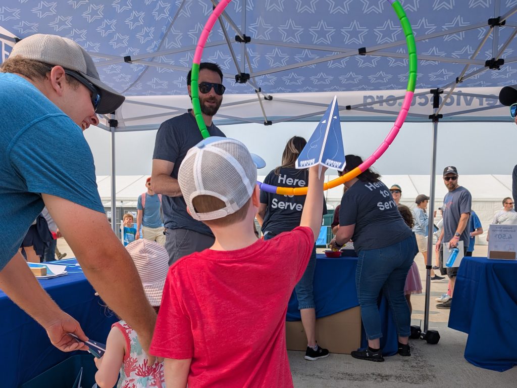 Children could fold Service CU branded paper airplanes and test fly them at the Service CU booth at the Air Show.