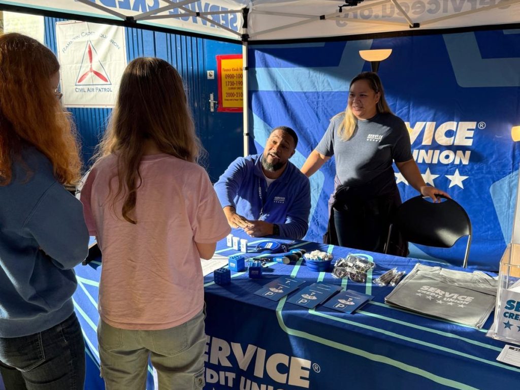 Service CU was on site with a table, handing out shopping bags to help shoppers carry home their finds. 