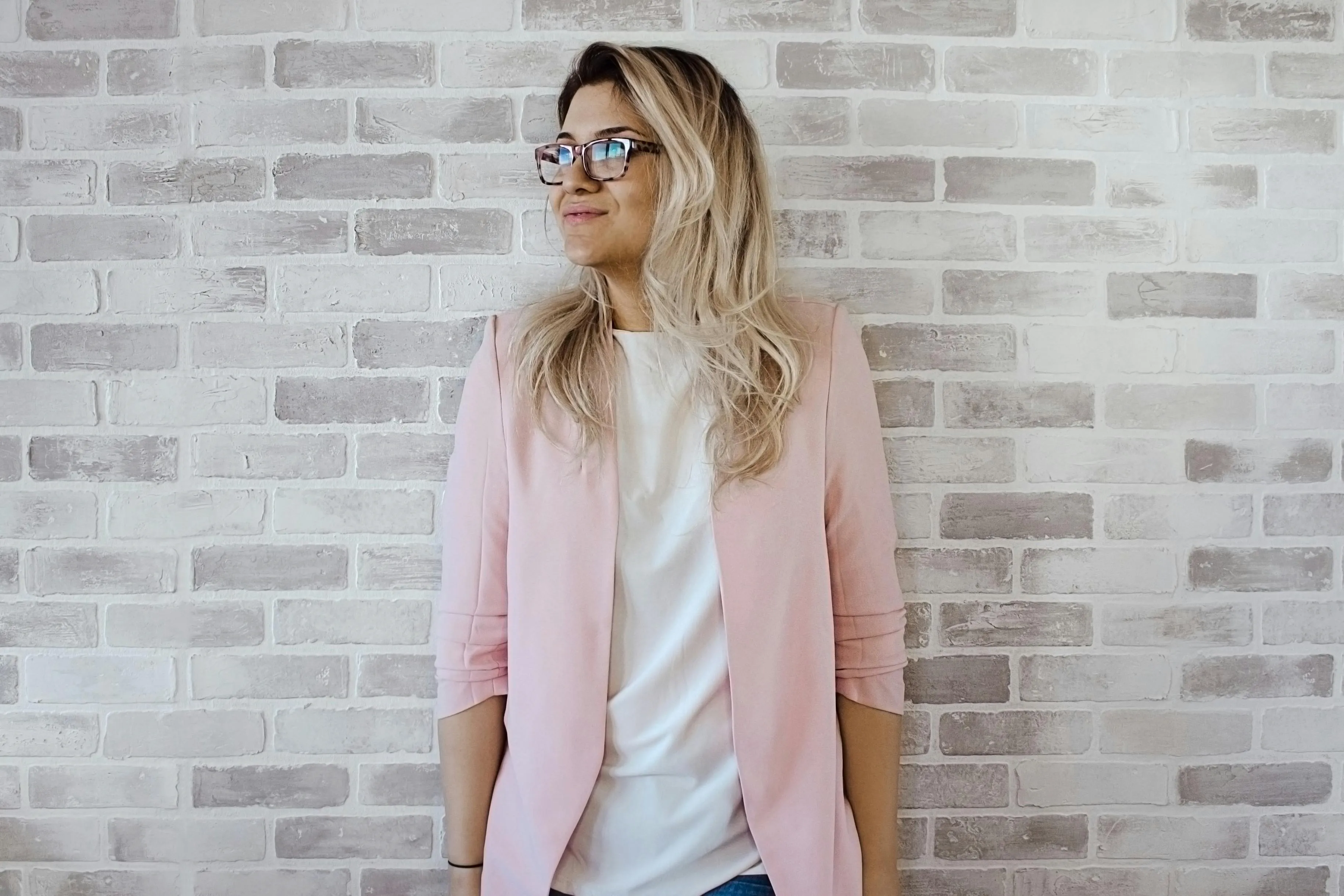 women in pink blazer