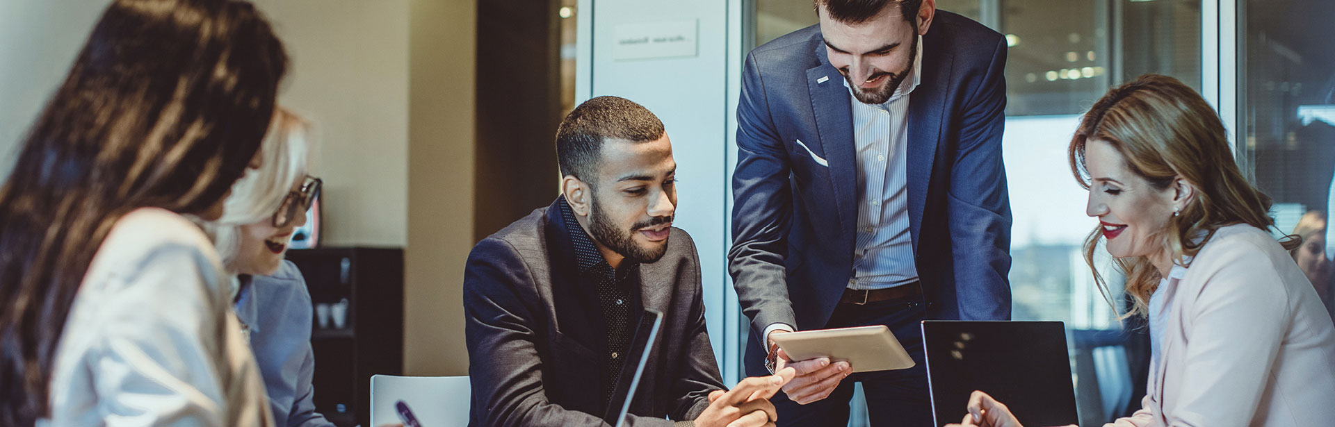 Business men and women, gathered at a table