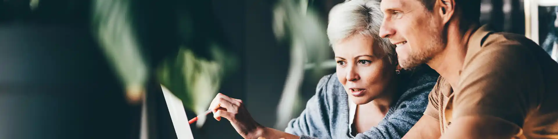 tow people looking at a laptop screen