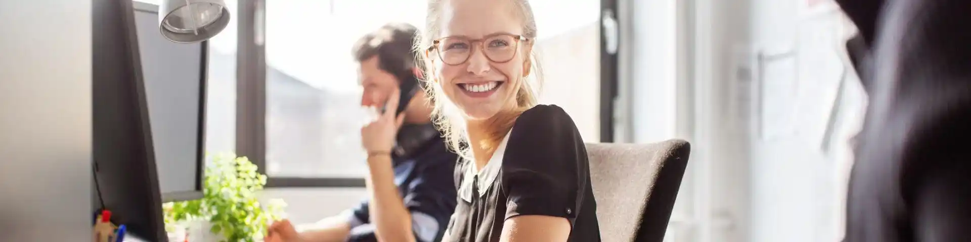 woman at work smiling at her co-worker