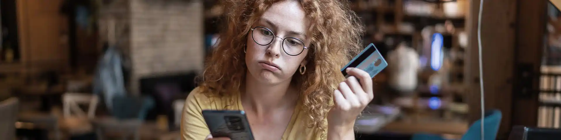 woman looking stressed about her credit card