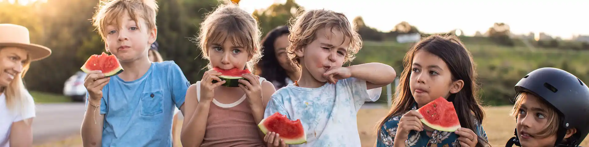 group of children eating watermelon